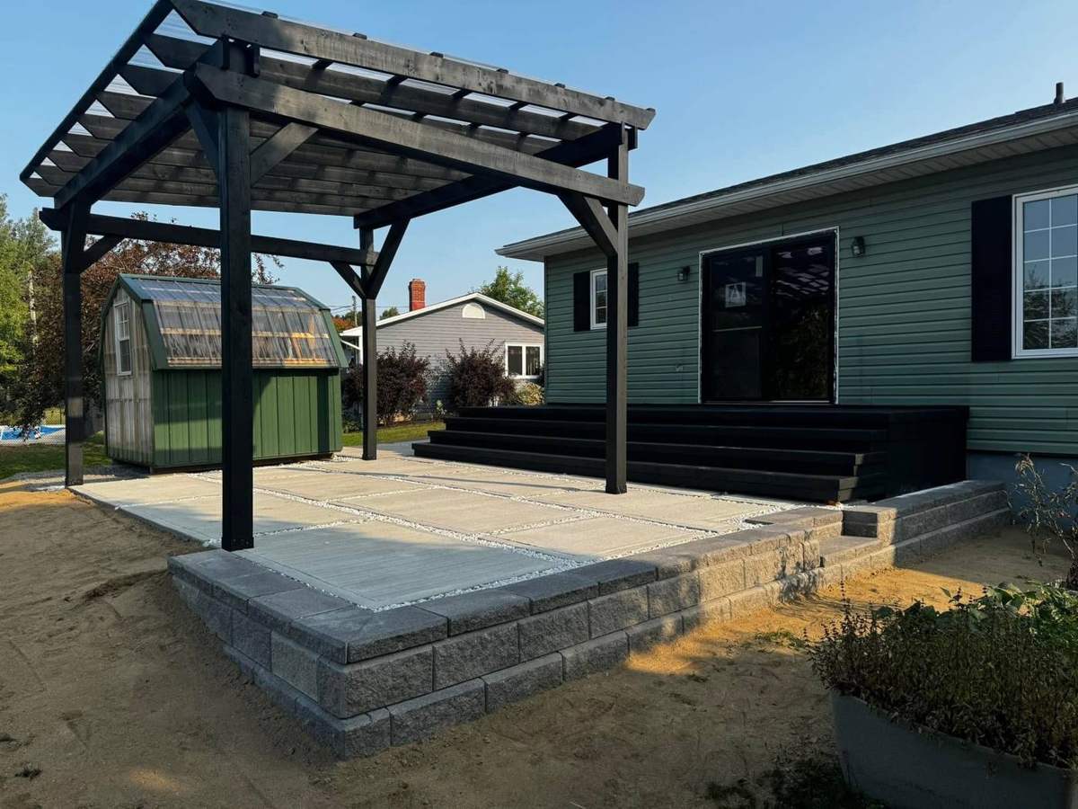 Raised slab patio, retaining wall and pergola