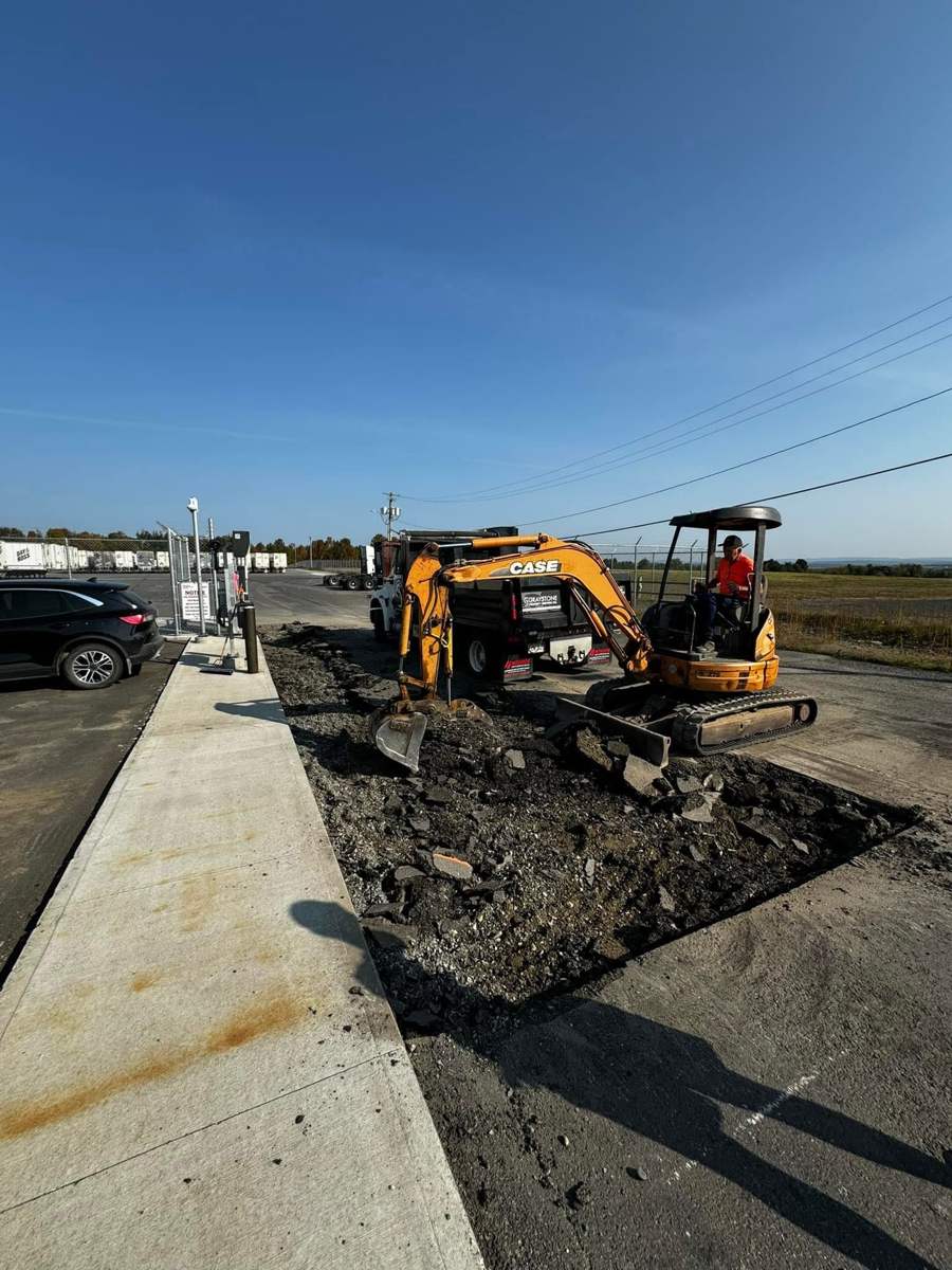 Removing old asphalt at a commercial trucking yard